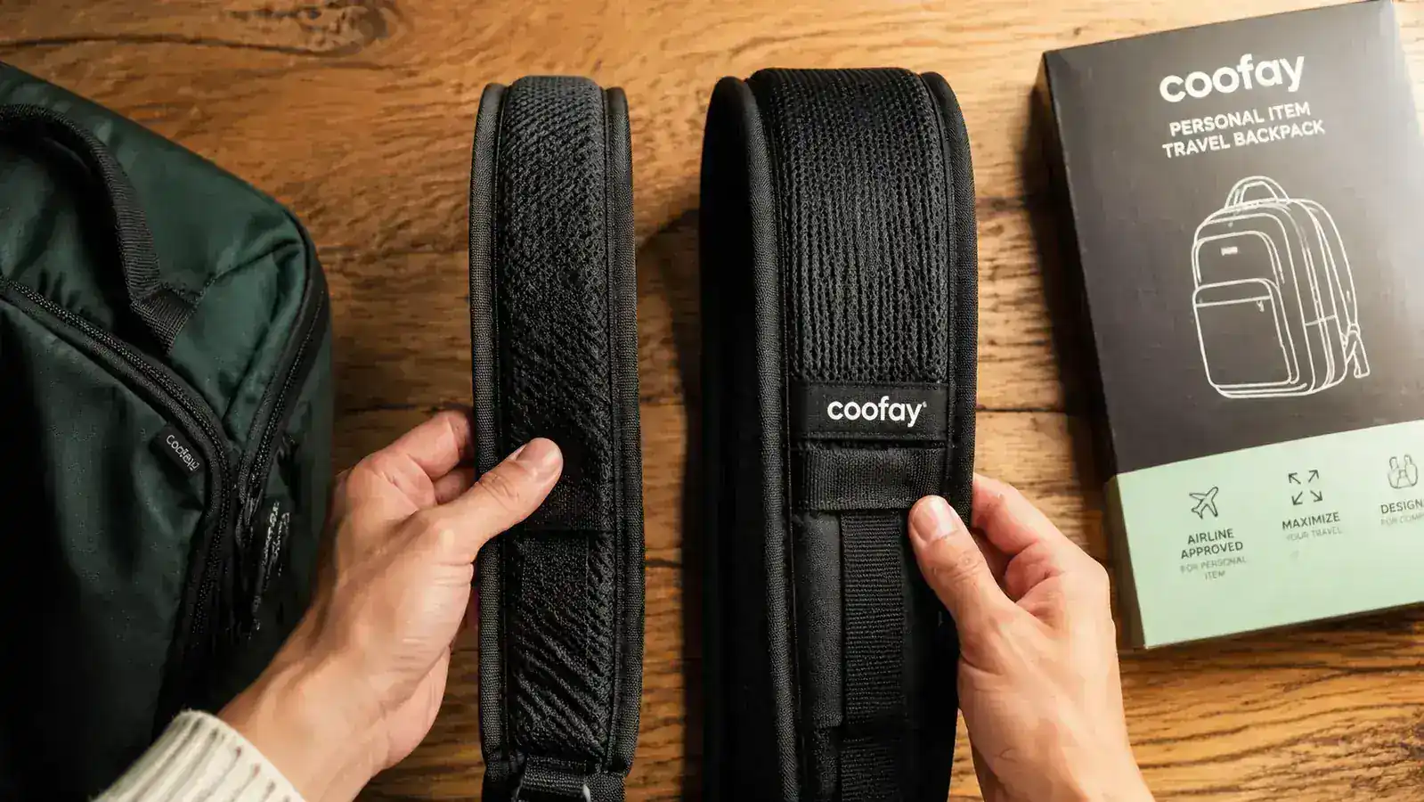 close-up of coofay backpack shoulder straps laid flat, showing thin foam padding compared to a thicker strap beside it