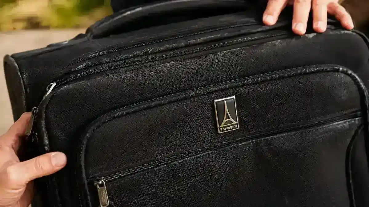 Travelpro Maxlite 5 softside shell showing subtle scuff marks on the fabric exterior after heavy use