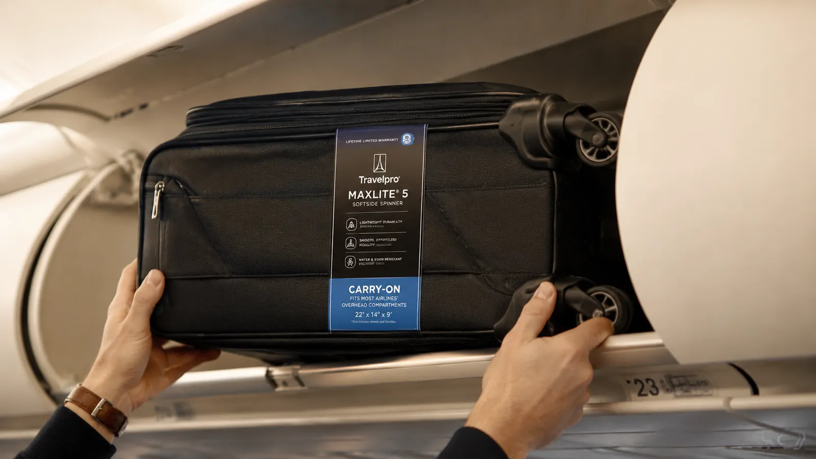 Travelpro Maxlite 5 carry-on being loaded into an overhead bin on an airplane